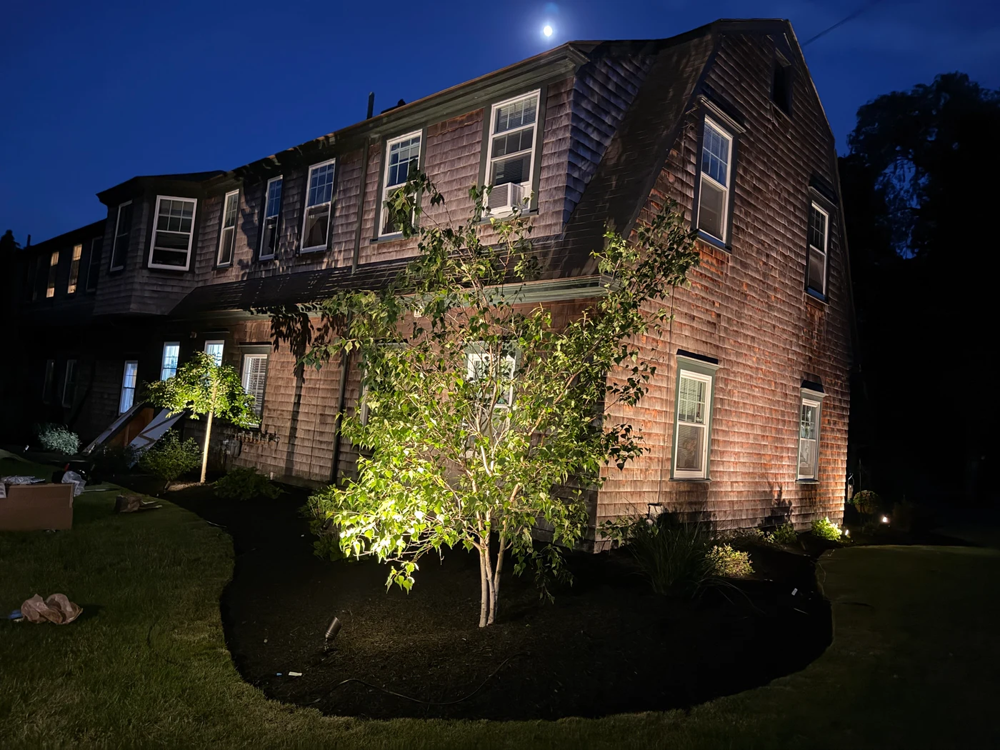 Cedar shingle home with tree uplighting, North Kingston RI